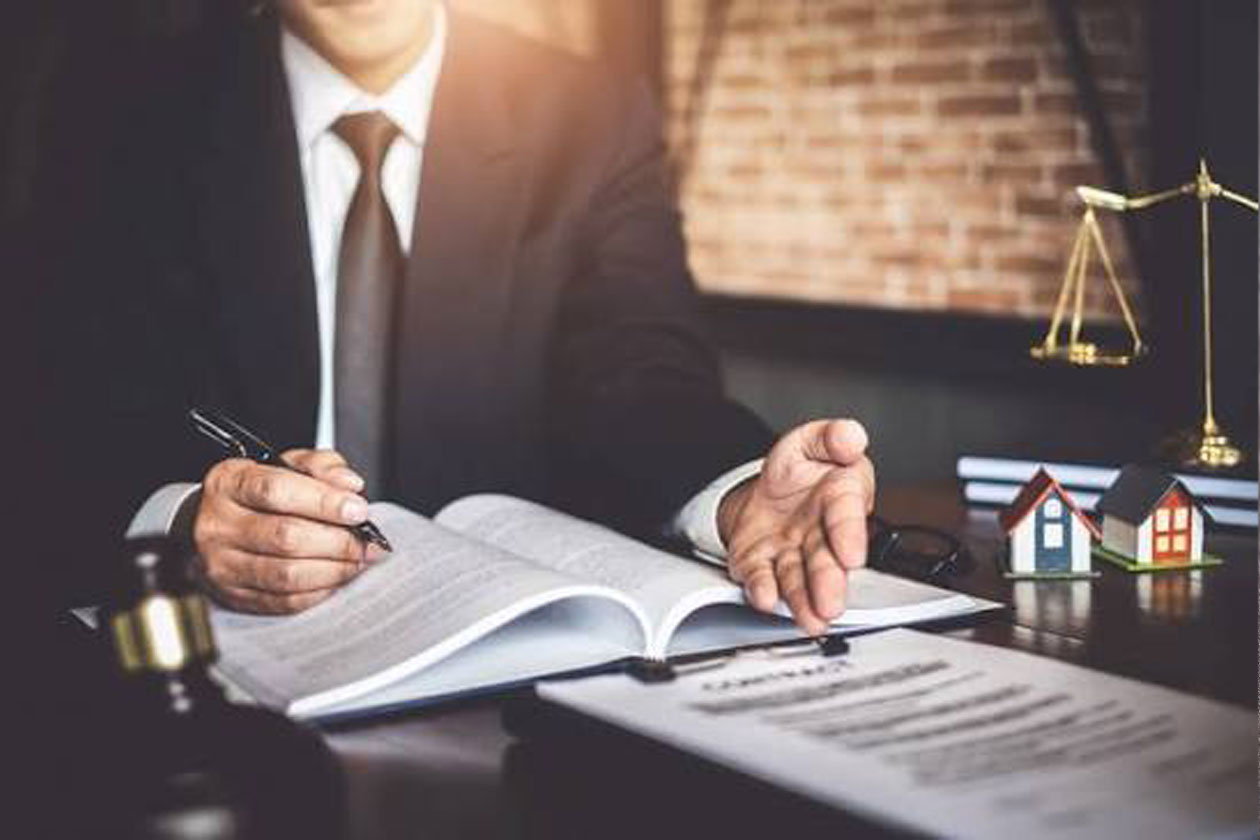 Corporate advisory and commercial law contract signing with gavel and property model, Dubai